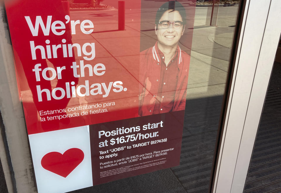 FILE - A sign advertising for holiday workers is displayed at a Target store Wednesday, Oct. 26, 2022, in Sheridan, Colo. Employers have shrugged off rising interest rates, higher costs and fears of recession and just kept hiring. After creating a record 6.7 million jobs last year, they've been adding another 420,000 a month in 2022. (AP Photo/David Zalubowski, File)