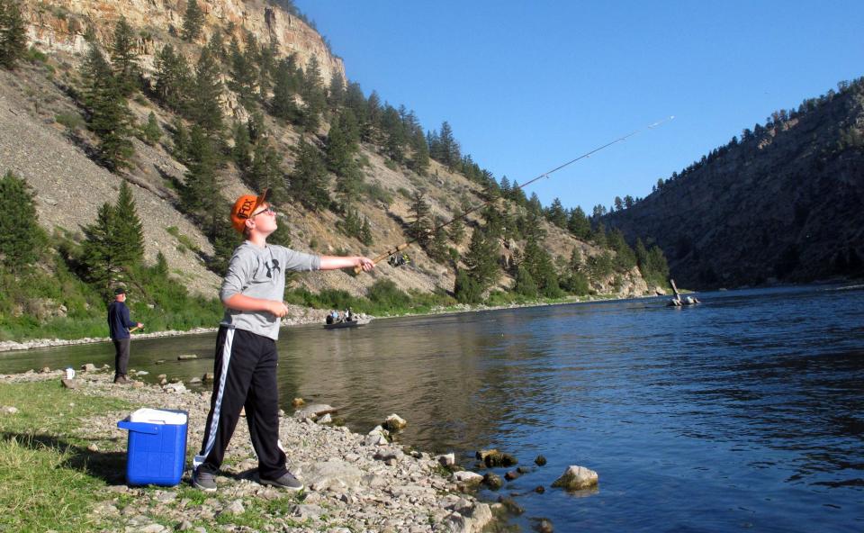 In this Aug. 1, 2012 photo, Ethan Stratton casts a line into the Missouri River near Helena, Mont., near his grandfather Lloyd Wilbur. More anglers are fishing on larger rivers and earlier in the day as heat and drought lead to restrictions on several small streams in Montana and in Yellowstone National Park.