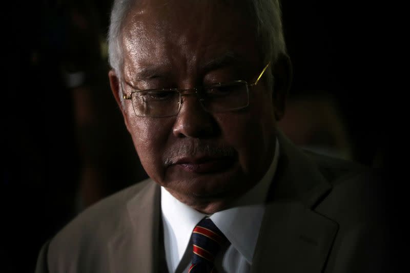 Former Malaysian Prime Minister Najib Razak reacts during a news conference outside Kuala Lumpur High Court in Kuala Lumpur