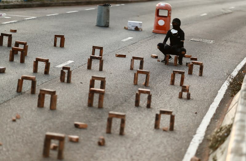 A student protester builds a roadblock outside the City University in Kowloon Tong, Hong Kong