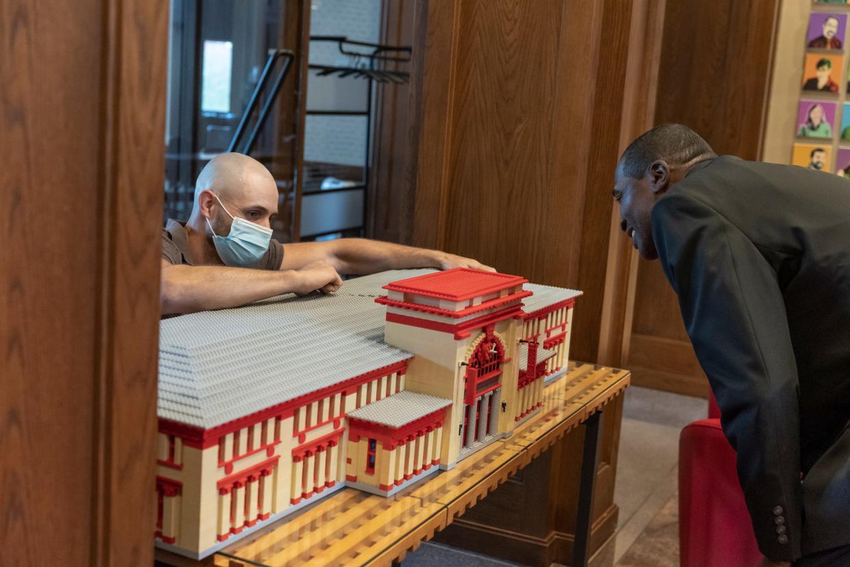 In the lobby of the Rhode Island Foundation's offices, Elgin Tagger looks on as Andrew Grover installs a Lego replica of the Downtown Providence building. While the building, facing Burnside Park, is probably best known as the capital city’s former railroad station, it has also been the foundation's home for more than two decades.