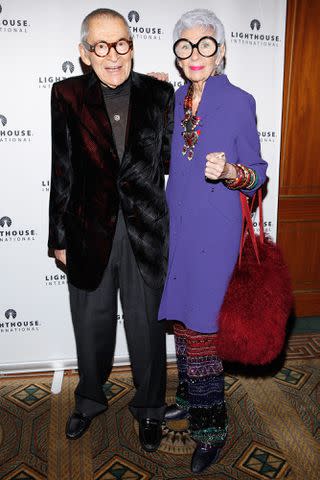 <p>Cindy Ord/Getty</p> Carl and Iris Apfel in 2012