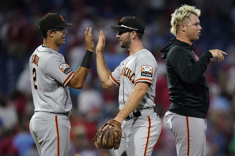 San Francisco Giants' Blake Sabol, from left, Paul DeJong and Joc Pederson celebrate after the Giants won a baseball game against the Philadelphia Phillies, Wednesday, Aug. 23, 2023, in Philadelphia. (AP Photo/Matt Slocum)