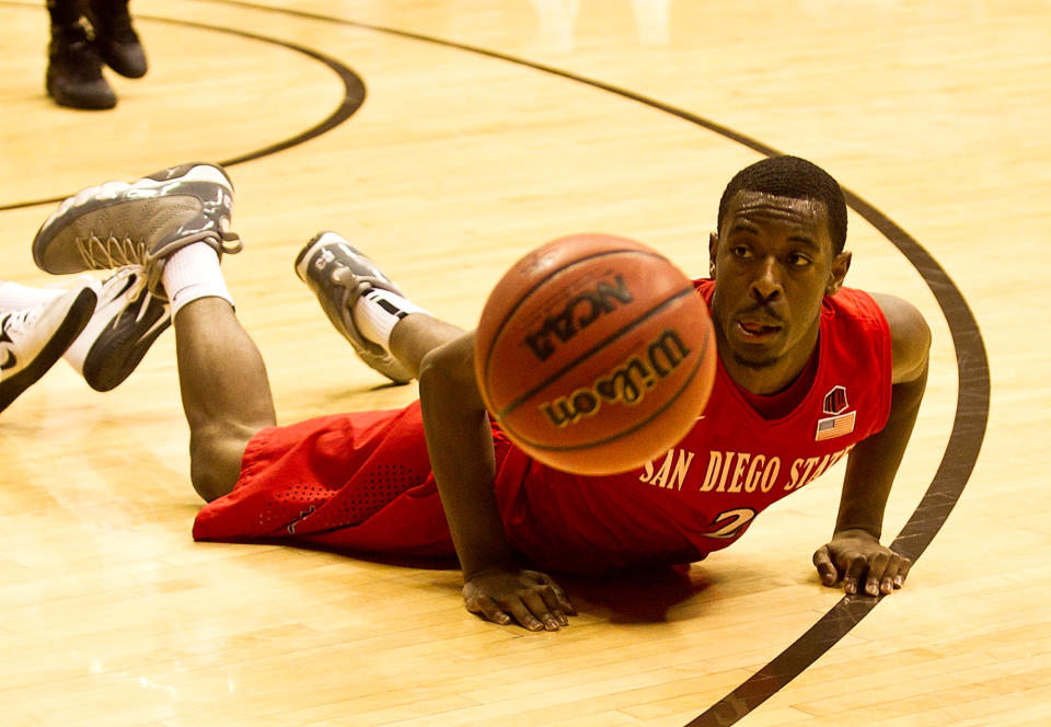 San Diego State guard Xavier Thames (2) dives after the ball Tuesday, Feb. 11, 2014, against the University of Wyoming at the Arena-Auditorium in Laramie, Wyo. (AP Photo/Jeremy Martin)