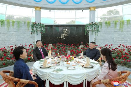 Chinese President Xi Jinping, his wife Peng Liyuan, North Korean leader Kim Jong Un and his wife Ri Sol Ju attend a luncheon during Xi's visit in Pyongyang