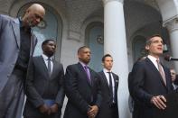 Los Angeles Mayor Eric Garcetti speaks as retired basketball star Kareem Abdul-Jabbar (L) and Sacramento Mayor Kevin Johnson (C), who is working on behalf of the National Basketball Players Association, stand by at a news conference outside City Hall, after National Basketball Association Commissioner Adam Silver made an announcement regarding Los Angeles Clippers owner Donald Sterling, in Los Angeles, California, April 29, 2014. The National Basketball Association on Tuesday banned Los Angeles Clippers owner Donald Sterling from the game for life for racist comments that outraged players, fans and the U.S. President. REUTERS/David McNew (UNITED STATES - Tags: SPORT POLITICS)