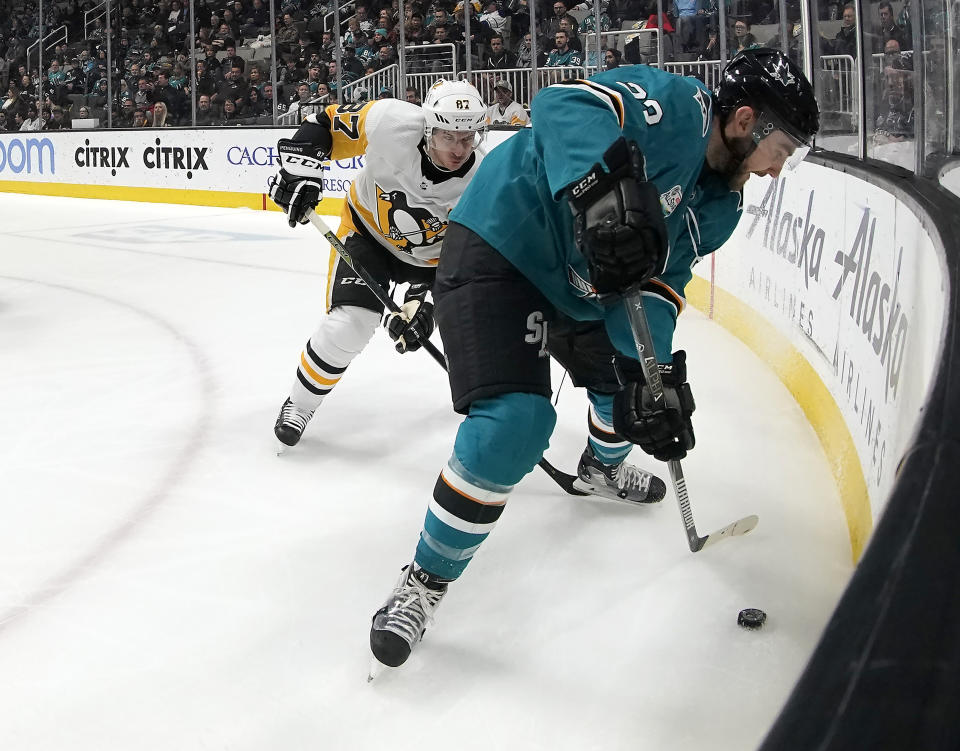 San Jose Sharks right wing Barclay Goodrow (23) battles for the puck against Pittsburgh Penguins center Sidney Crosby (87) during the first period of an NHL hockey game in San Jose, Calif., Tuesday, Jan. 15, 2019. (AP Photo/Tony Avelar)