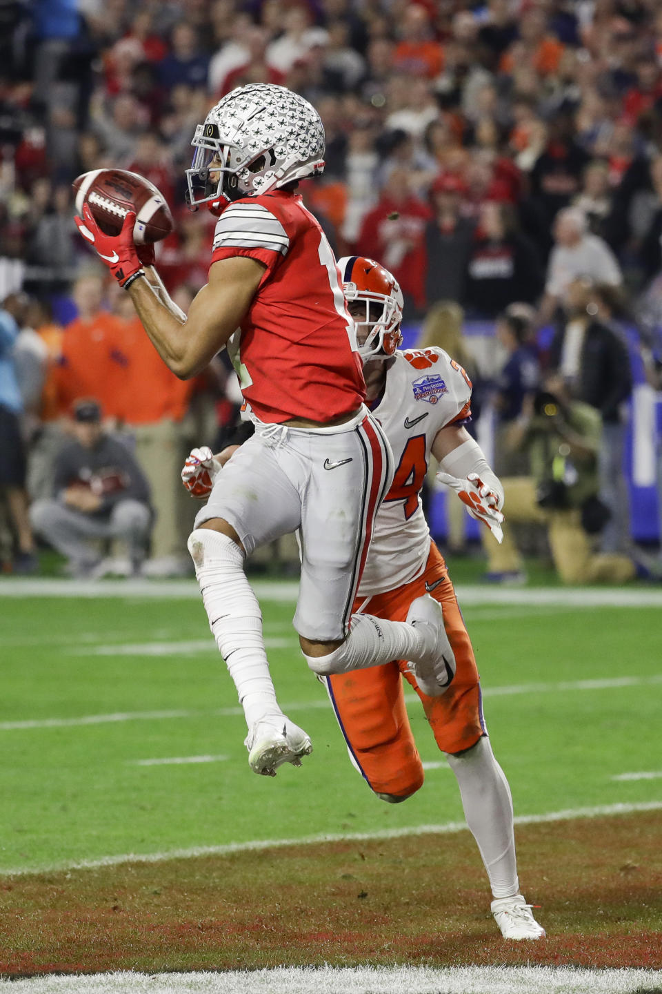 FILE - In this Saturday, Dec. 28, 2019, file photo, Ohio State wide receiver Chris Olave catches a touchdown pass in front of Clemson safety Nolan Turner during the second half of the Fiesta Bowl NCAA college football game in Glendale, Ariz. Ohio State hosts Nebraska on Saturday, Oct. 24, 2020. (AP Photo/Rick Scuteri, File)