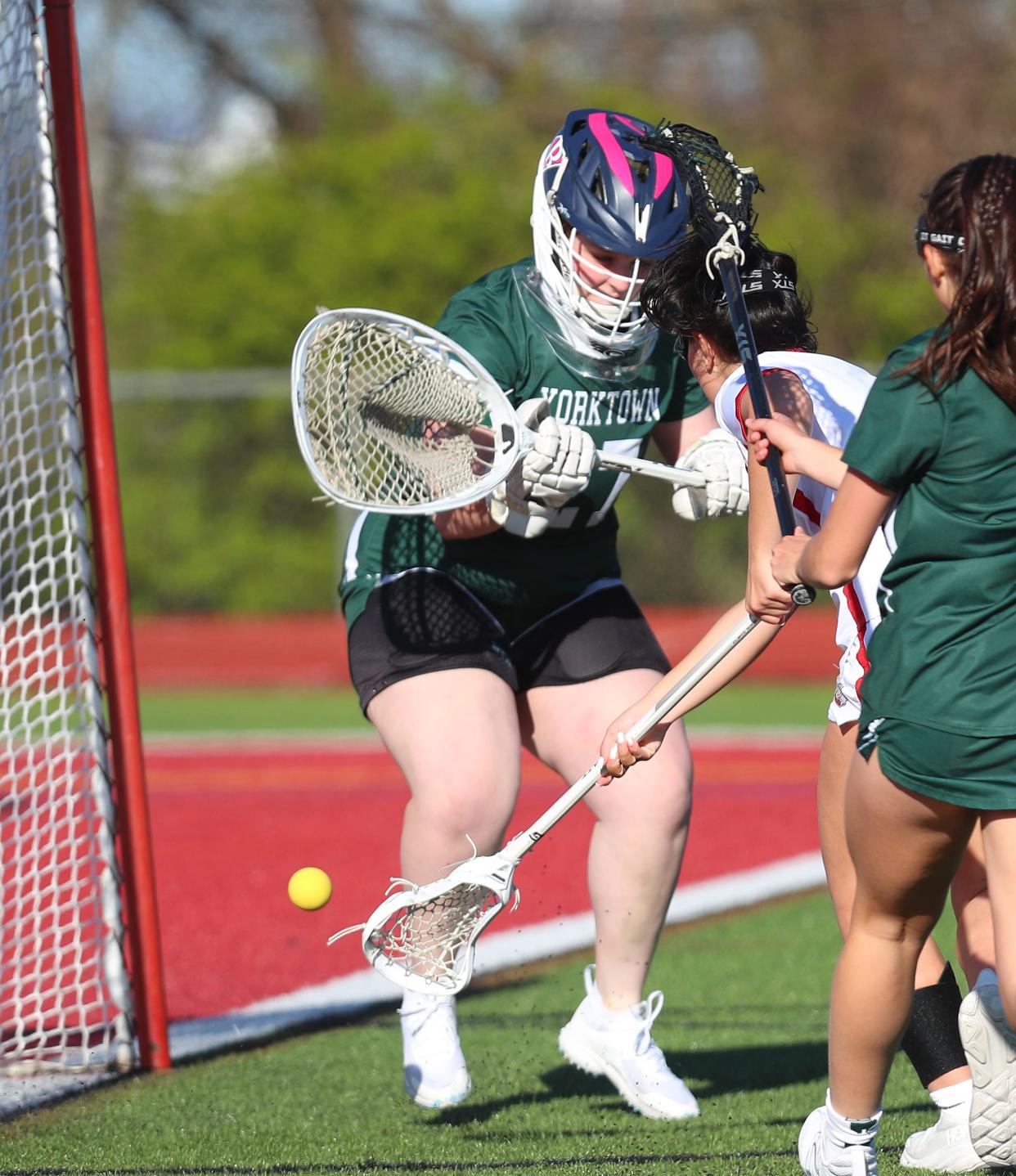 Yorktown goalie Annie Durante (27) blocks a shot from Somers Lyla Mancini (5) during girls lacrosse action at Somers High School April 25, 2024. Yorktown won the game 8-57