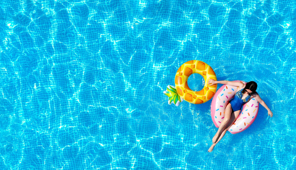 Woman on an inflatable water toy in the pool.