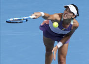 Spain's Garbine Muguruza serves to Kiki Bertens of the Netherlands during their fourth round singles match at the Australian Open tennis championship in Melbourne, Australia, Monday, Jan. 27, 2020. (AP Photo/Lee Jin-man)