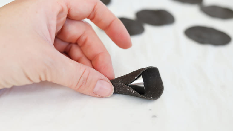 round of pasta dough around a piping tip