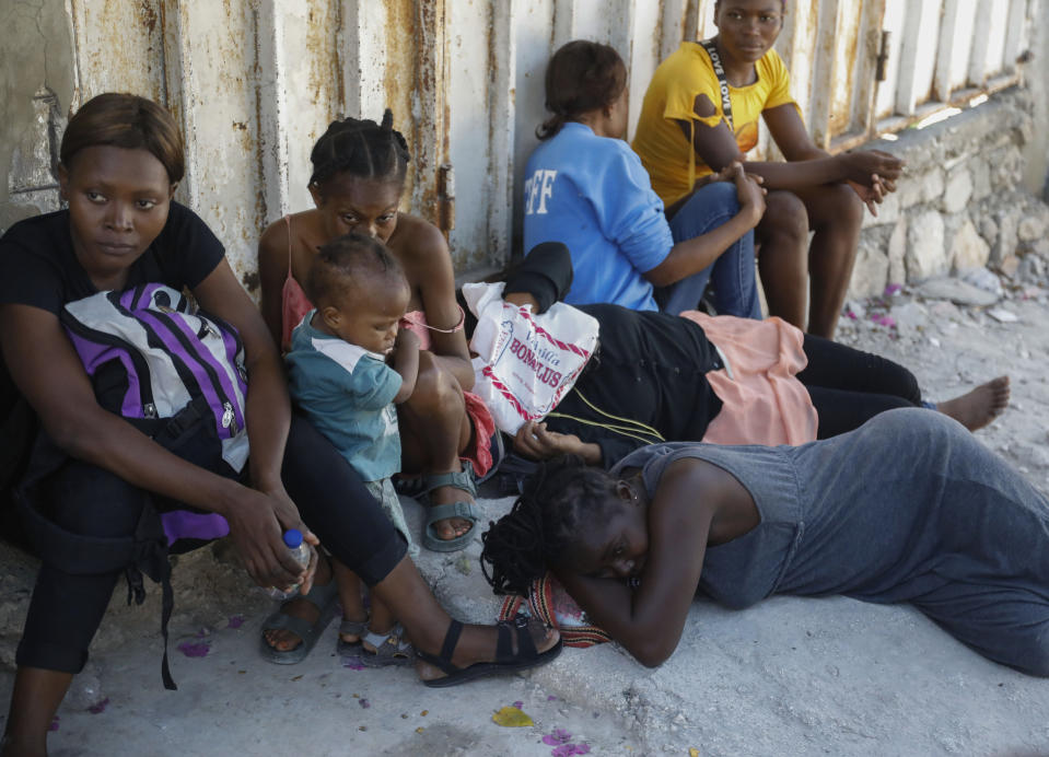 Residents of the Solino neighborhood, who were displaced from their homes due to clashes between armed gangs, rest on a street in the Carrefour community of Port-au-Prince, Haiti, Thursday, Jan. 18, 2024. (AP Photo/Odelyn Joseph)