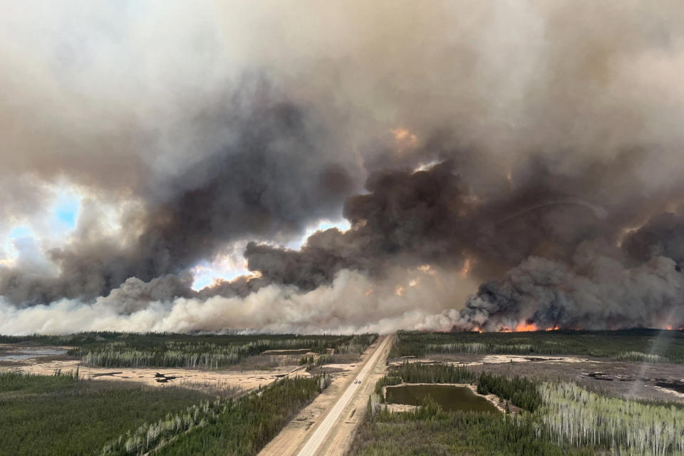 Smoke rises from mutual aid wildfire in the High Level Forest Area