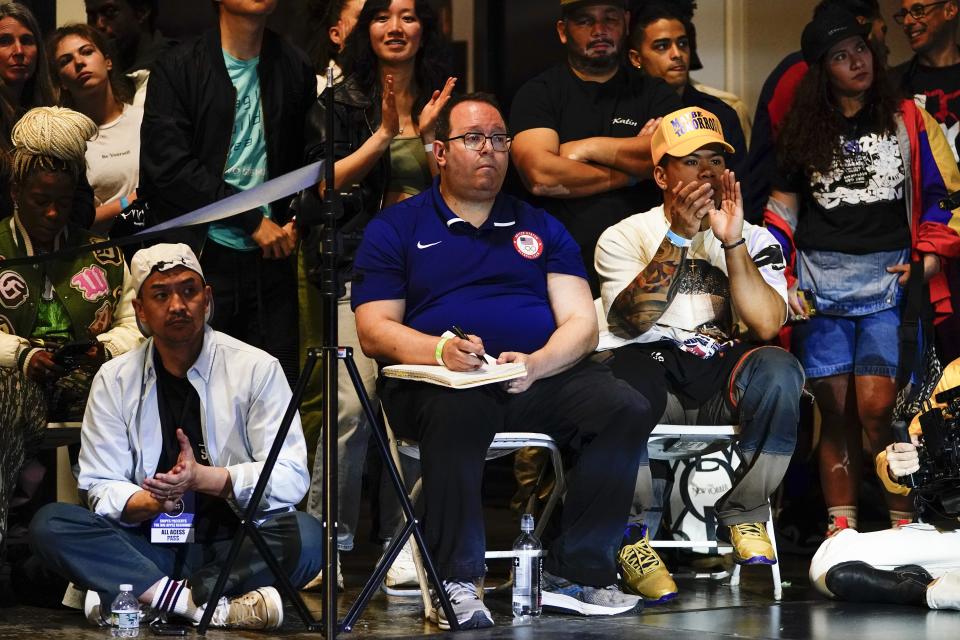 A Team USA Olympics official watches the Breaking for Gold Big Apple breakdancing regional competition Saturday, April 22, 2023, in the Brooklyn borough of New York. The hip-hop dance form makes its official debut at the Paris Games in 2024. (AP Photo/Frank Franklin II)