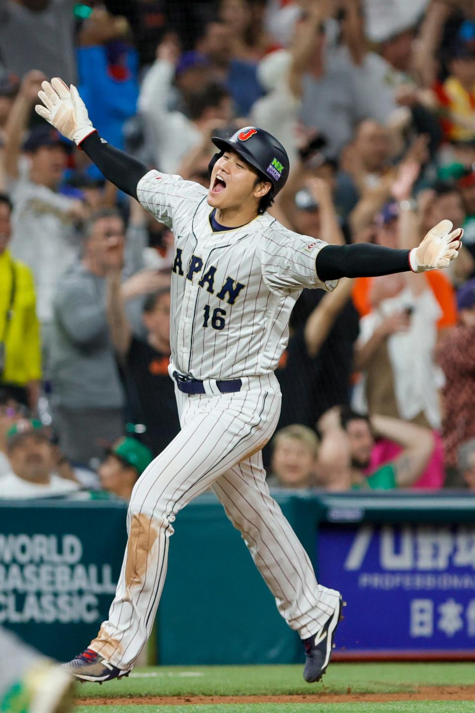 Shohei Ohtani circles the bases after a three-run home run by Masataka Yoshida against Mexico.