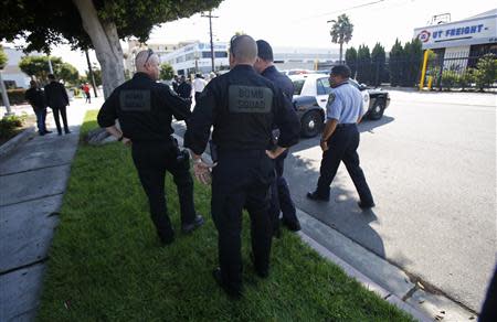 Sheriff's Department Bomb Squad officers and other officers are pictured in the vicinity of the apartment complex of suspect Nna Alpha Onuoha in Inglewood, California September 11, 2013. REUTERS/Mario Anzuoni