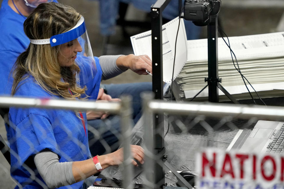 Maricopa County ballots cast in the 2020 general election are examined and recounted by contractors working for Florida-based company, Cyber Ninjas, Thursday, May 6, 2021 at Veterans Memorial Coliseum in Phoenix. The audit, ordered by the Arizona Senate, has the U.S. Department of Justice saying it is concerned about ballot security and potential voter intimidation arising from the unprecedented private recount of the 2020 presidential election results. (AP Photo/Matt York, Pool)