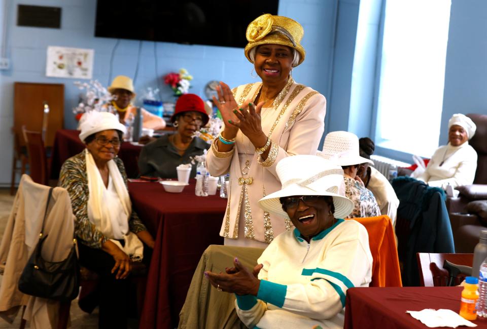 Carrie Thornton, 82, of Detroit, stands to clap and sing "Happy Birthday" to Deon Mullen, 40, the senior director of senior outreach services at Franklin Wright Settlements in Detroit, on Tuesday, April 4, 2023. Over 20 seniors were there for the twice-weekly "Food and Friendship," where they play games, do exercise routines and have lunch. Usually during Easter time, the seniors have food for an Easter celebration delivered to their homes but that couldn't happen this year so Mullen made sure that the seniors had Easter dinner they could take home with them to make.