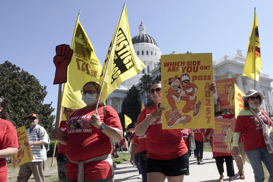 Fast-food workers and their supporters march past the state Capitol calling on passage of a bill to provide increased power to fast-food workers, in Sacramento, California on Tuesday, Aug. 16, 2022. (Rich Pedroncelli / AP)