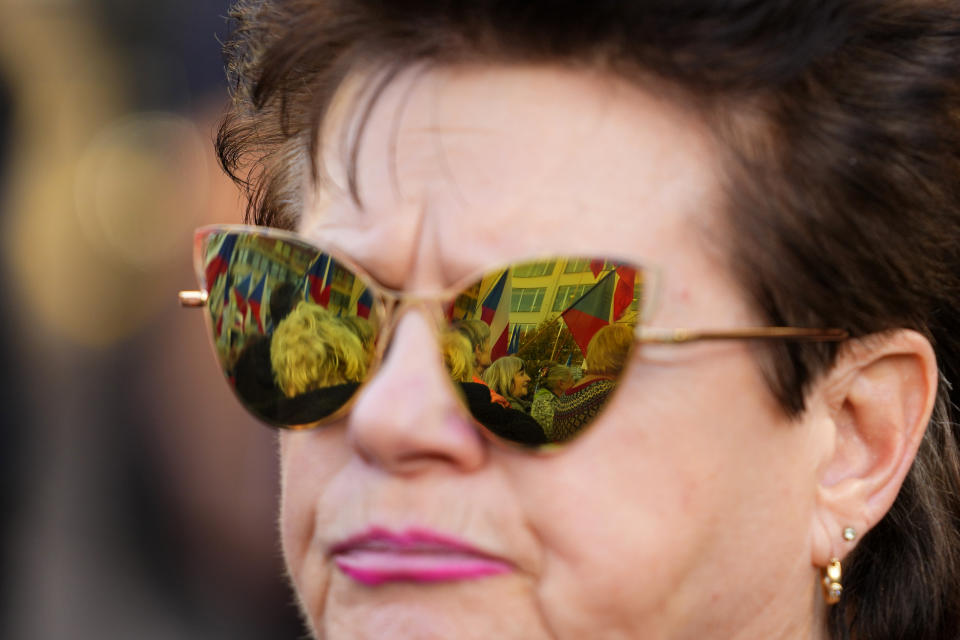 People reflect in glasses as several thousands of protesters from the far right and far left gathered to rally against the country's pro-Western Czech government at the Vencesla's Square in Prague, Czech Republic, Friday, Oct. 28, 2022. (AP Photo/Petr David Josek)