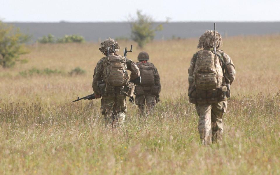 File image: British soldiers on exercise walks across an area of Salisbury Plain - REUTERS/Peter Nicholls