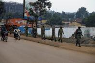 Ugandan security forces walk in a formation in Kampala