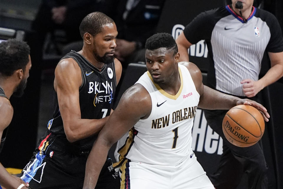 Brooklyn Nets' Kevin Durant (7) defends New Orleans Pelicans' Zion Williamson (1) during the first half of an NBA basketball game Wednesday, April 7, 2021, in New York. (AP Photo/Frank Franklin II)