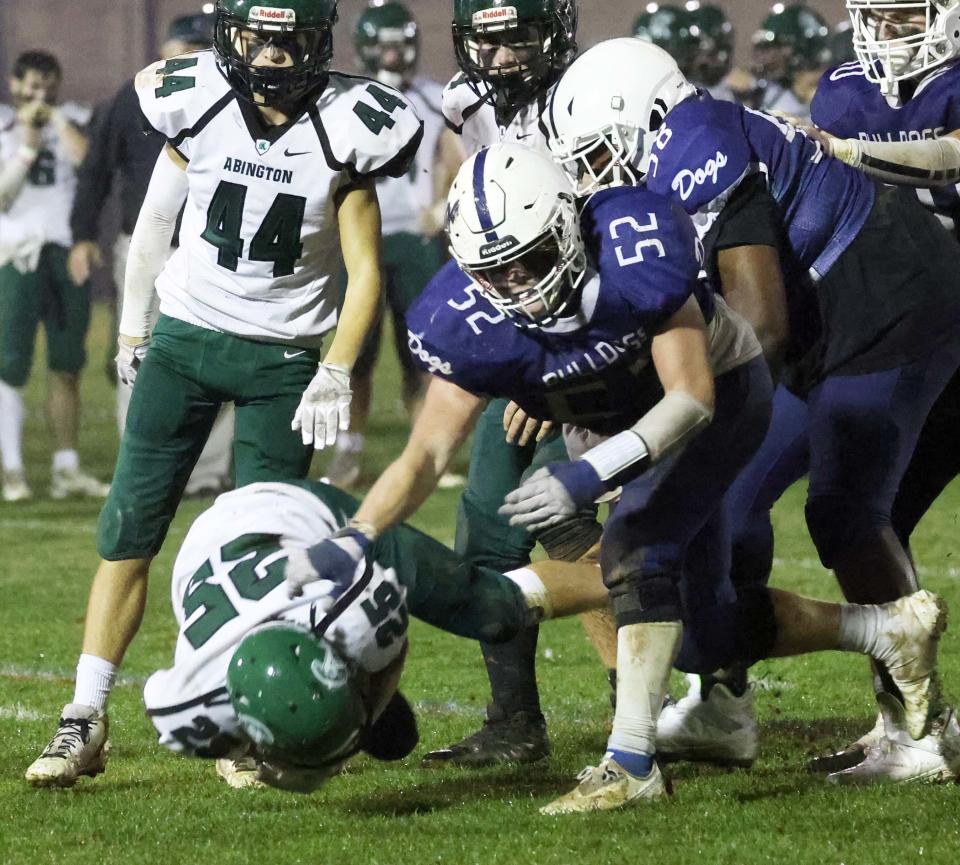 Rockland's Leary Costa throws down Abington running back Ryan Simonetti in the backfield for a loss of yards during a game on Friday, Nov. 11, 2022.