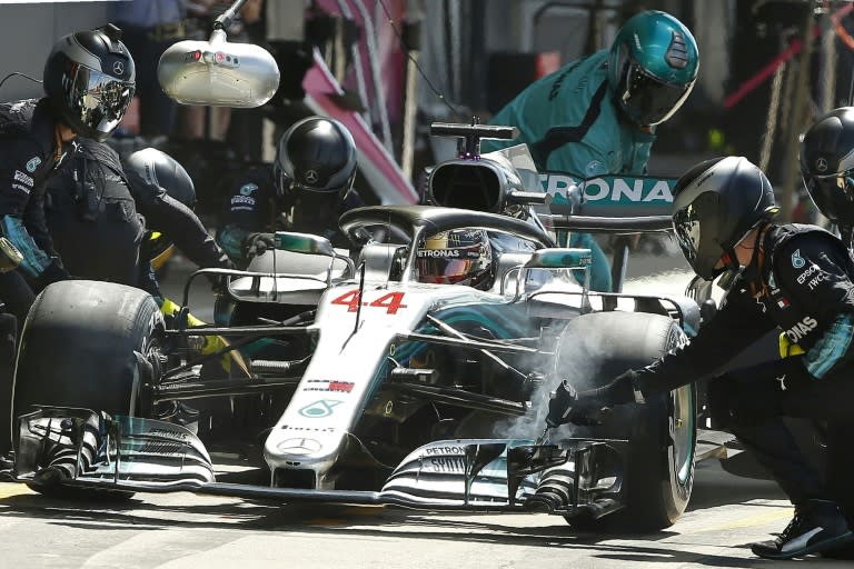 Lewis Hamilton makes a pit stop as the Mercedes team work on his tyres at the recent British Grand Prix