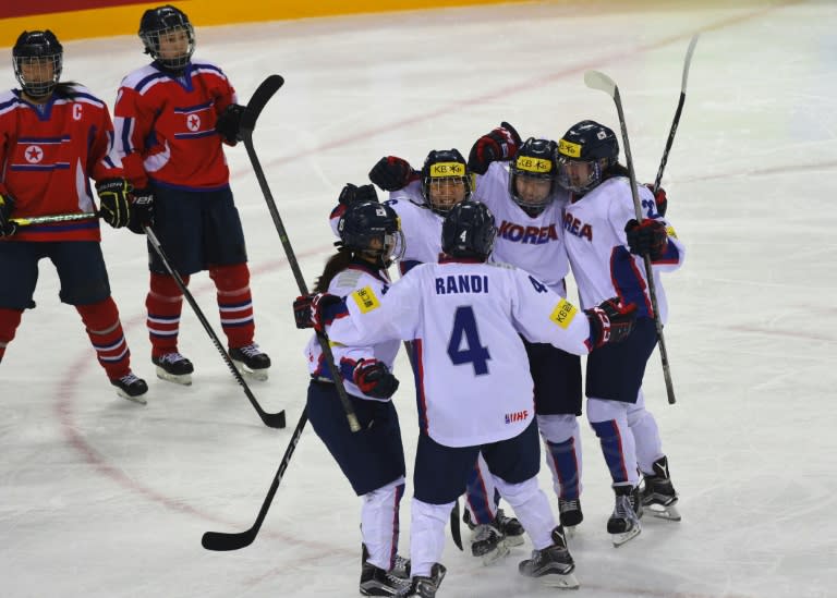 South Korea (white) celebrates after scoring against North Korea during their IIHF women's world ice hockey championships match in Gangneung on April 6, 2017