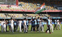 Indian players celebrate after defeating Australia by three wickets on the final day of the fourth cricket test at the Gabba, Brisbane, Australia, Tuesday, Jan. 19, 2021.India won the four test series 2-1. (AP Photo/Tertius Pickard)