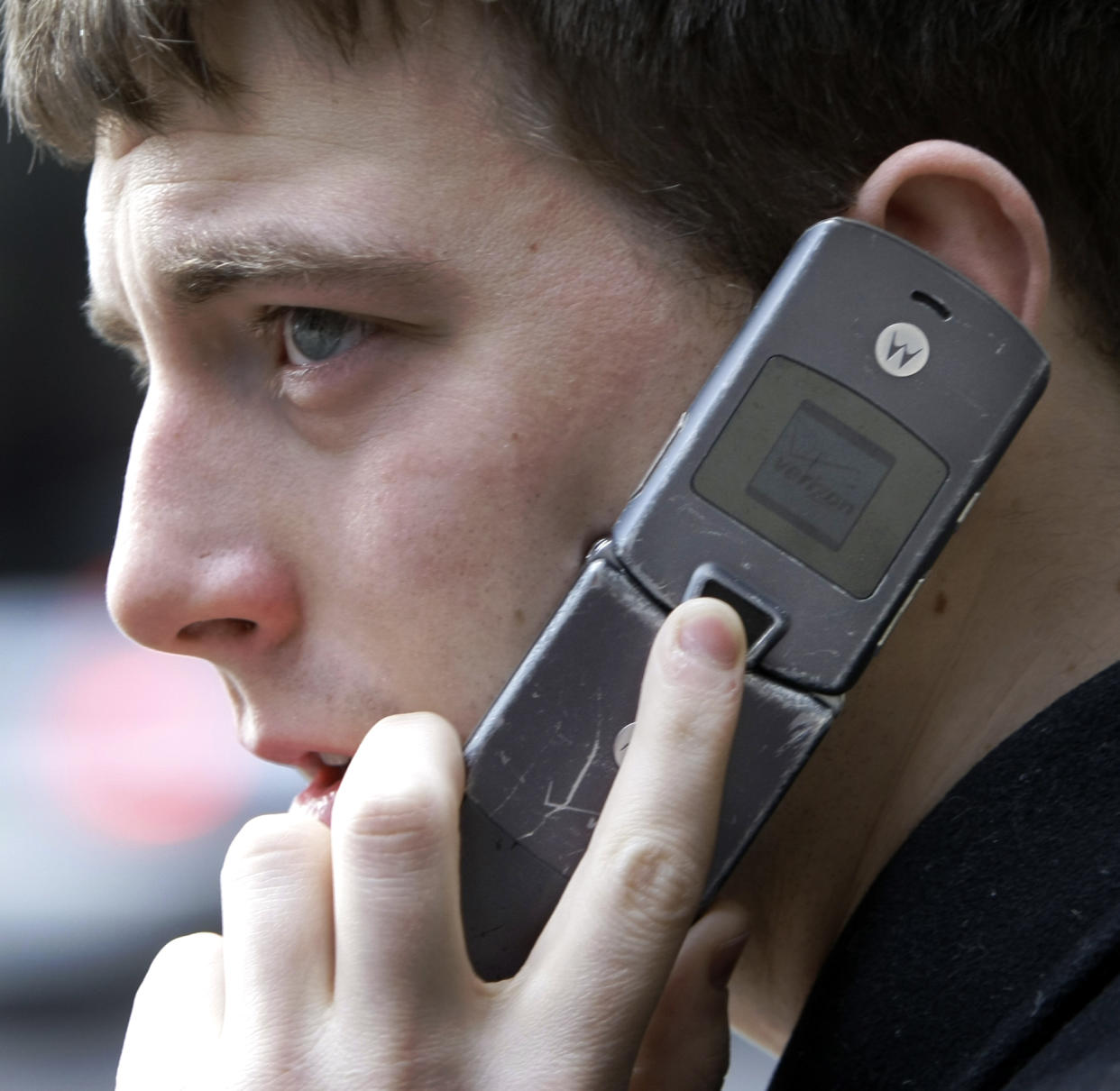 A pedestrian talks on his Motorola Razr cell phone while walking in downtown Chicago in 2009 (AP Photo/Charles Rex Arbogast)