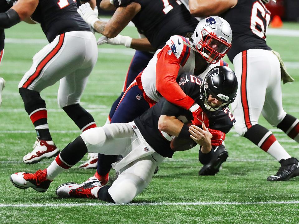 Atlanta Falcons quarterback Matt Ryan is sacked for a loss by New England Patriots linebacker Matthew Judon on third down forcing a punt during the second quarter in an NFL football game on Thursday, Nov. 18, 2021, in Atlanta. (Curtis Compton/Atlanta Journal-Constitution via AP)