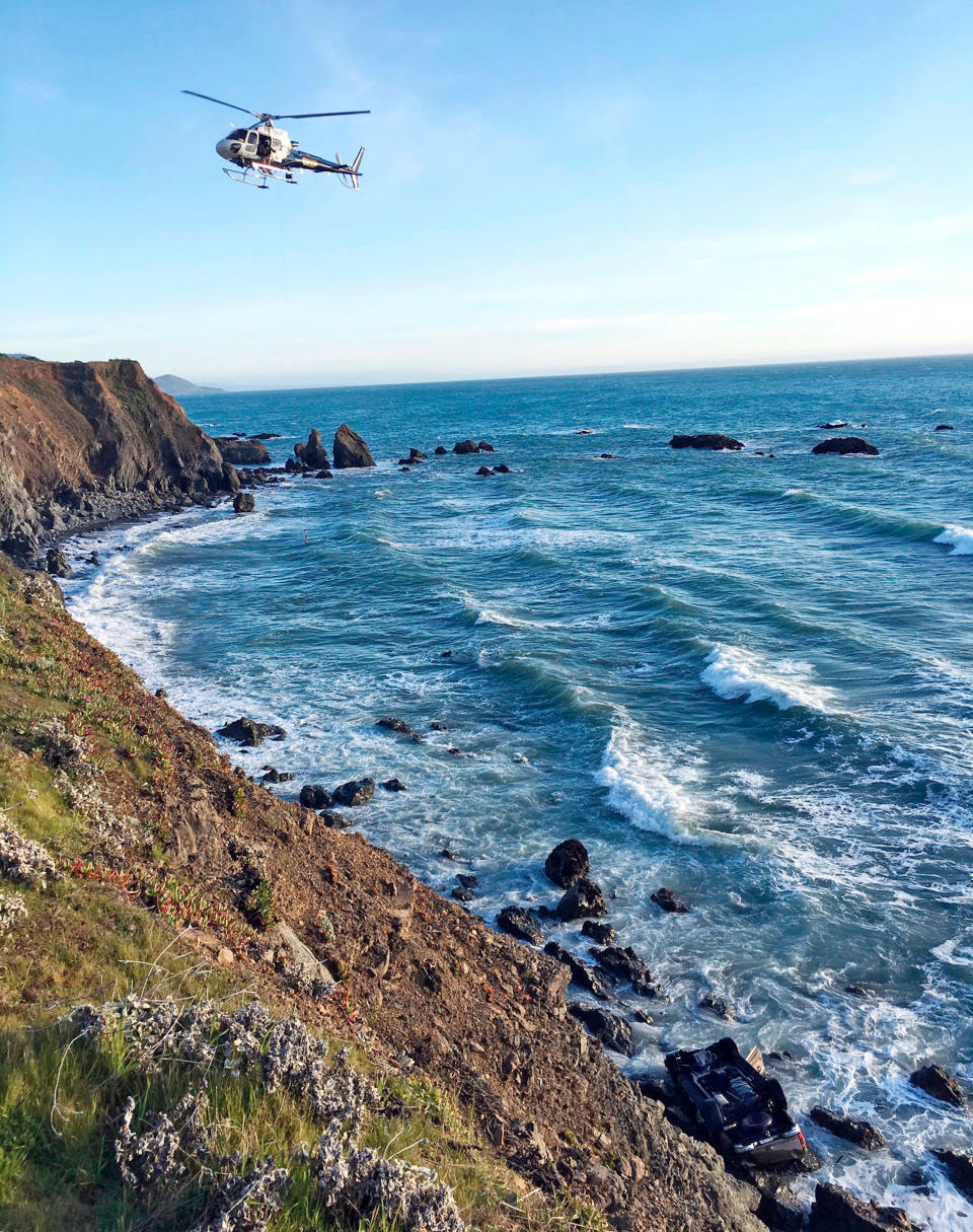 A California Highway Patrol a helicopter hovers over steep coastal cliffs near Mendocino, California, where Jen and Sarah Hart’s vehicle plunged off, killing them and their six adopted children. Source: California Highway Patrol via AP