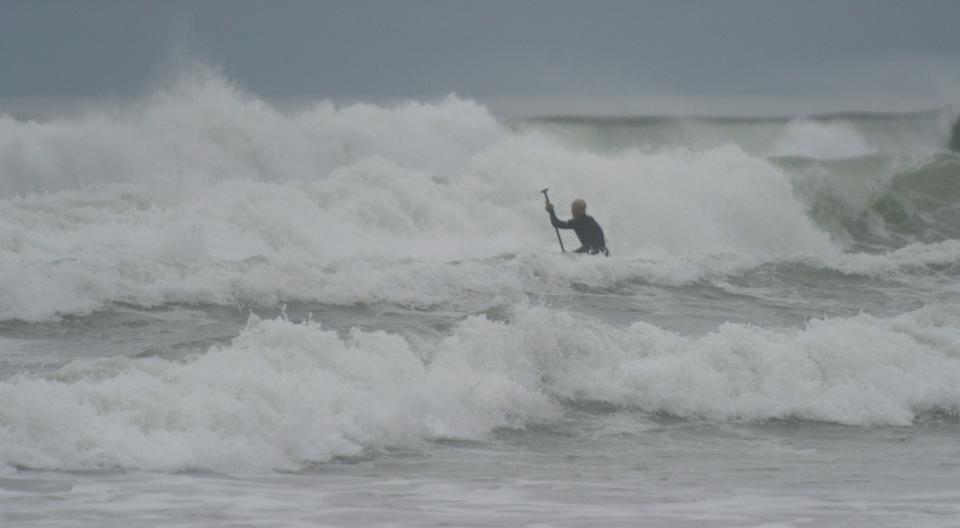 A standup paddleboarder makes his way from Nauset Light Beach in North Eastham into the heavy surf in this photo from September 2022.