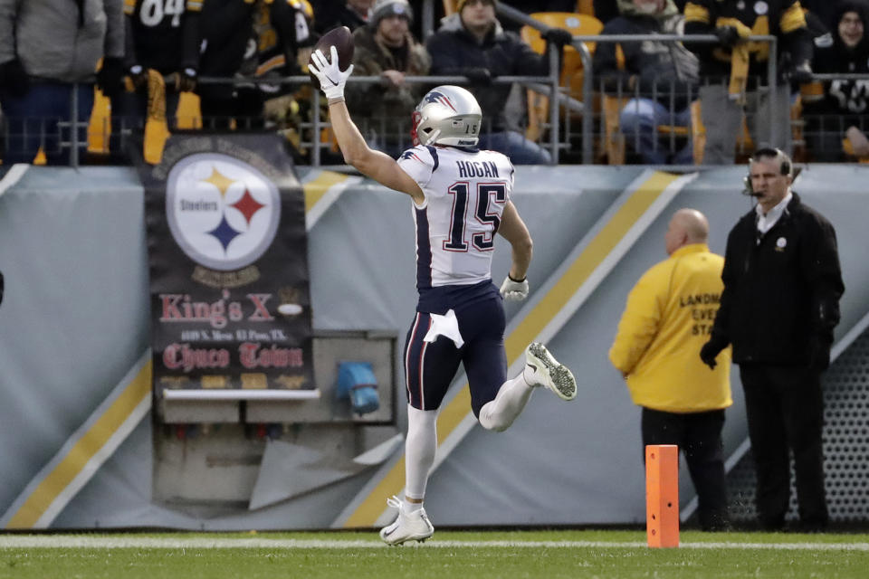 New England Patriots wide receiver Chris Hogan (15) scores after taking a pass from quarterback Tom Brady during the first half of an NFL football game against the Pittsburgh Steelers in Pittsburgh, Sunday, Dec. 16, 2018. (AP Photo/Don Wright)