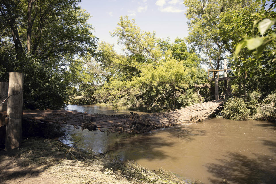 A bridge crossing Beaver Creek, on the property of Lori Lems, is devastated after flooding in the area over the weekend. Wednesday, June 26, 2024, in Canton, SD. (AP Photo/Josh Jurgens)