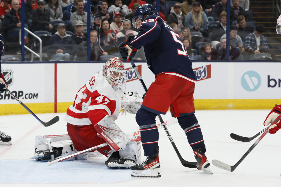 Detroit Red Wings' James Reimer, left, makes a save against Columbus Blue Jackets' Emil Bemstrom during the second period of an NHL hockey game Monday, Oct. 16, 2023, in Columbus, Ohio. (AP Photo/Jay LaPrete)