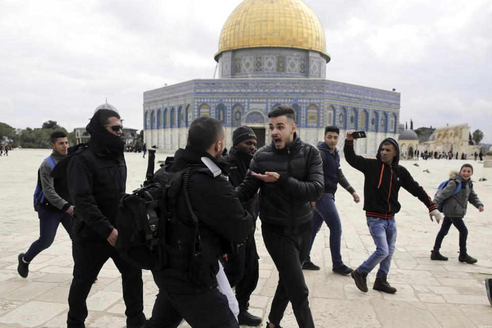 Israeli police confronts Palestinians in front of the Dome of the Rock mosque in Jerusalem, Monday, Feb. 18, 2019. Israeli police officers have arrested several Palestinians for "causing a disturbance" at a flashpoint Jerusalem holy site. The men took part in a prayer protest Monday outside a section of the Temple Mount that has been closed by Israeli court order for over a decade. (AP Photo/Mahmoud Illean)