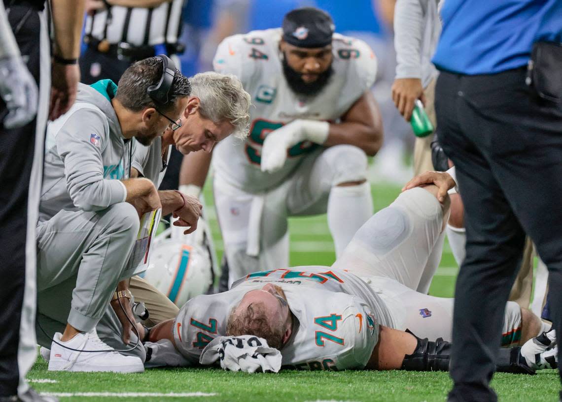 Miami Dolphins head coach Mike McDaniel watches over offensive tackle Liam Eichenberg (74) as he is attended to after injury in the third quarter during game against the Detroit Lions at Ford Field in Detroit, Michigan on Sunday, October 30, 2022.