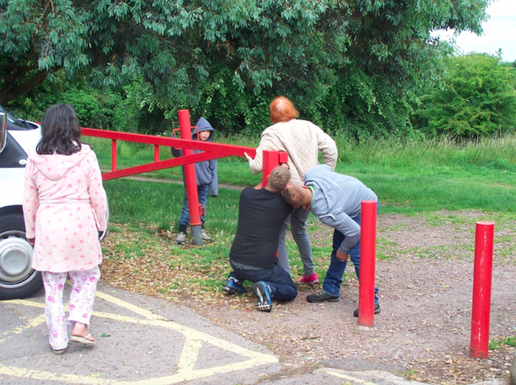 The pensioner wrapped herself around the gate when she saw the travellers (SWNS)