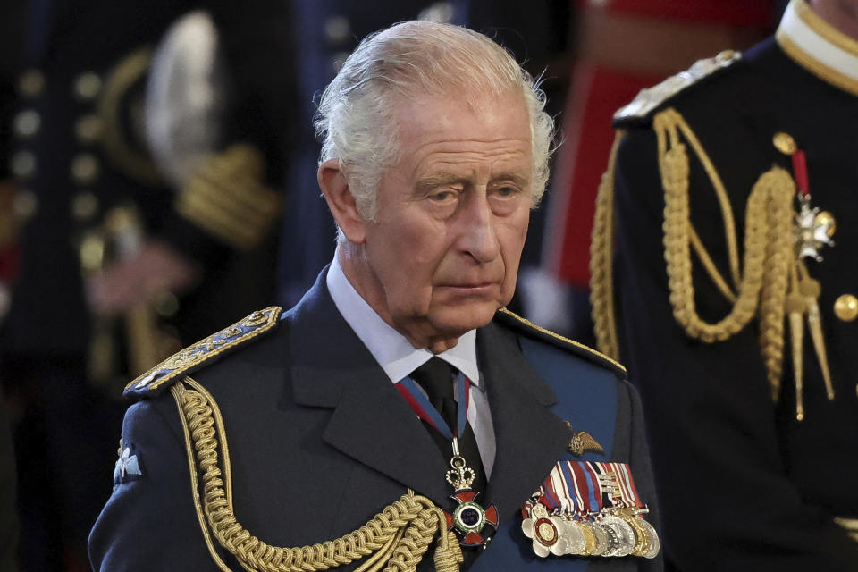 Britain's King Charles reacts as the coffin of Britain's Queen Elizabeth II arrives at Westminster Hall from Buckingham Palace for her lying in state, in London, Britain, Wednesday, Sept. 14, 2022. (Alkis Konstantinidis/Pool photo via AP)