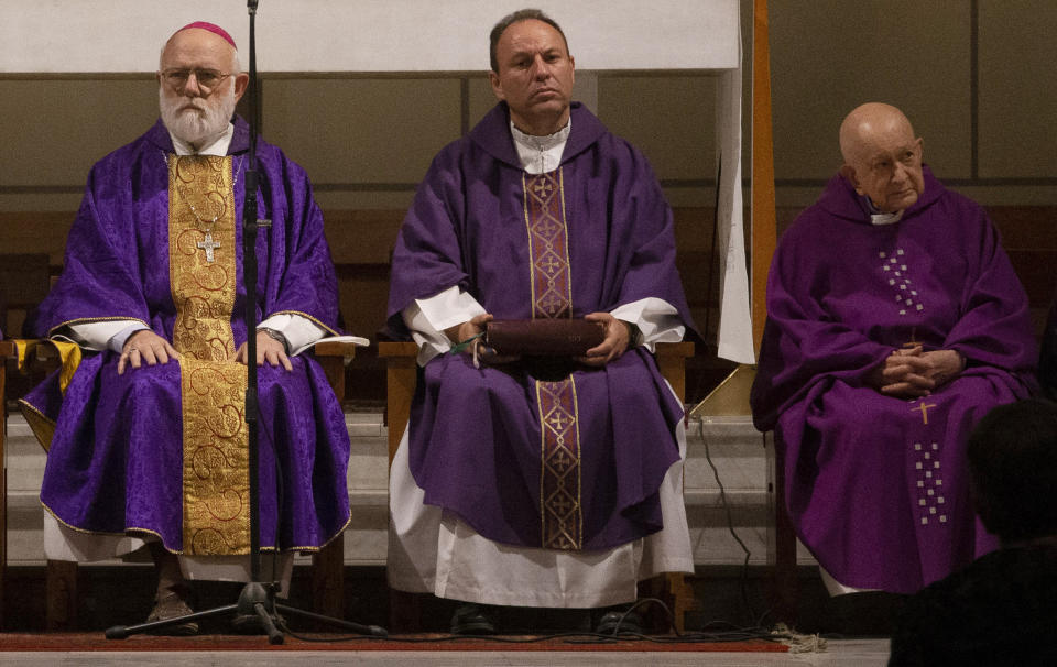 In this March 28, 2019 photo, Bishop Carlos Eugenio Irarrázabal, center, sits on the altar during Mass with acting archbishop of Santiago, Monsignor Celestino Aos, left, at El Bosque Parish in Santiago, Chile. The priest at right is unidentified. Pope Francis accepted Irarrázabal's resignation just 24 days after he appointed him to the post of auxiliary bishop of the Chilean capital, church officials said Friday, June 14, 2019. (AP Photo/Esteban Felix)