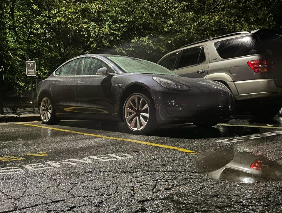 a Tesla parked in an apartment lot