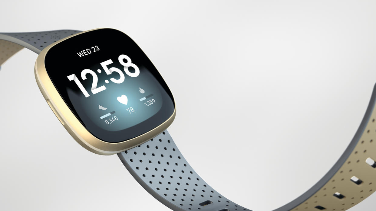  Light blue and gold Fitbit Versa 3 on neutral background 