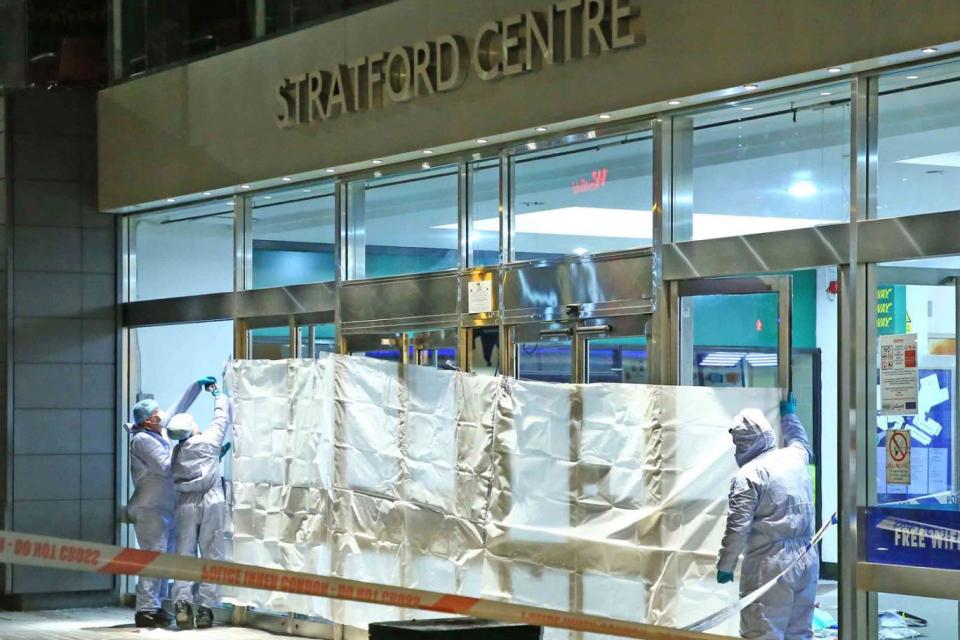 Police and Forensic officers at the crime scene in Stratford after a man was stabbed to death (Nigel Howard)