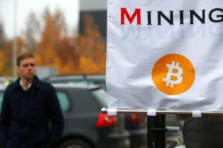 A man walks past bitcoin mininig show booth during Riga Comm 2017, a business technology and innovation fair in Riga, Latvia November 9, 2017. REUTERS/Ints Kalnins