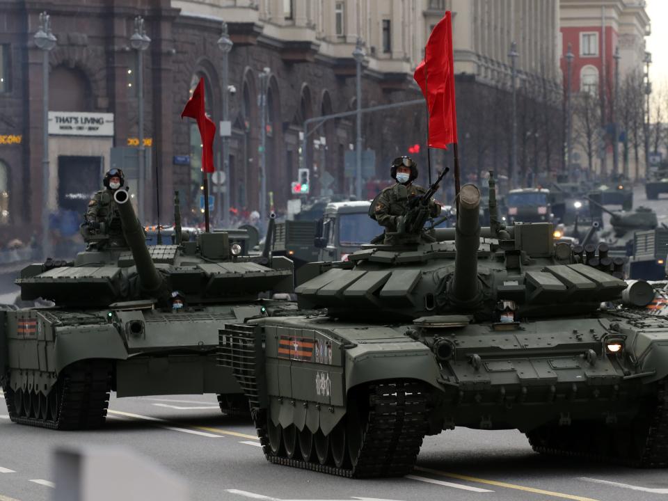 Russian military servicemen wear face masks to protect against the coronavirus (COVID-19) and ride a heavy T-90 tank during the first city rehearsals of the Victory Day military parade, on April 29, 2021 in Moscow, Russia.