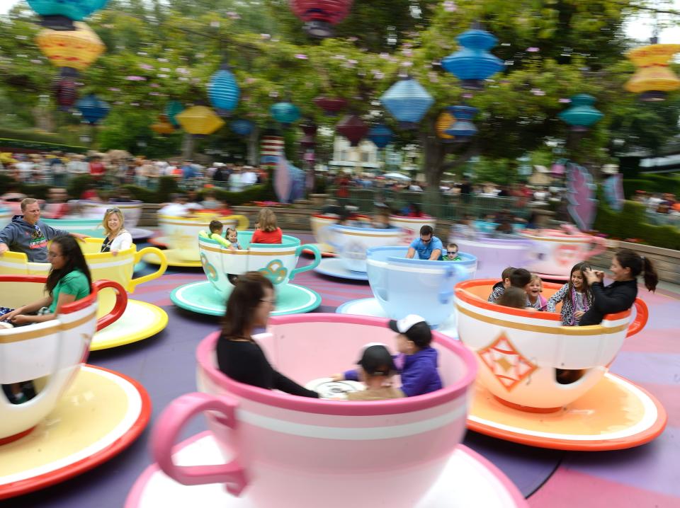 People spinning around on the teacups at disney